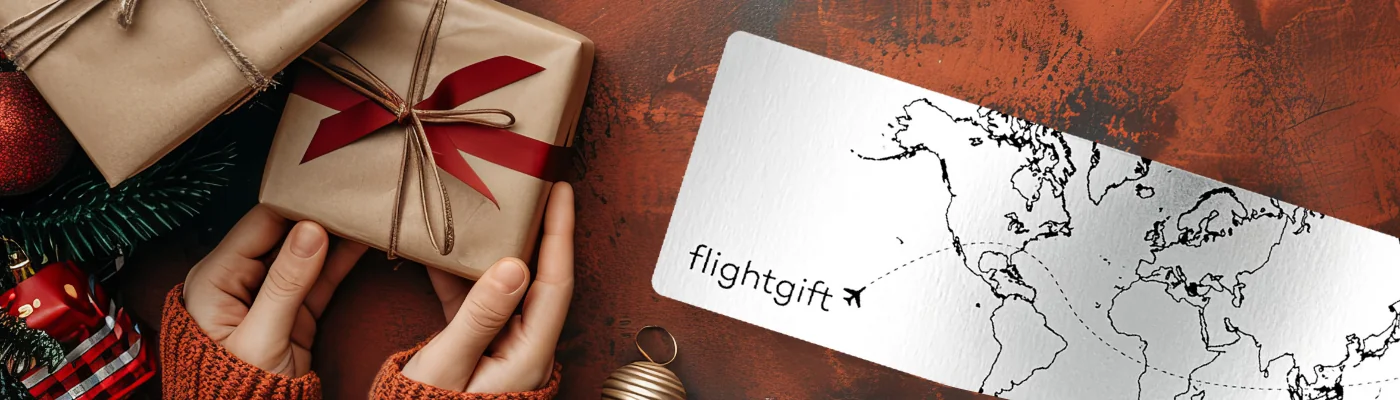 Hands holding Gifts Next to Airline Ticket with World Map - Christmas Themed